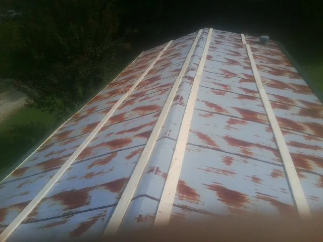 Rusted metal roof panels with new wood purlins before replacement — Storm Damage Roof Repair in Barnegat by Roofing Brothers